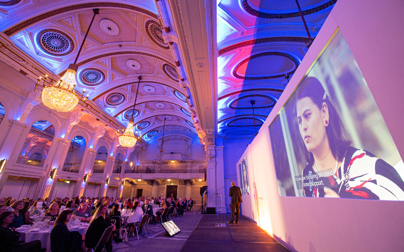 Dr Saraswati Dawadi is shown on screen at the Research Excellence Awards explaining the human trafficking project at the launch of the People's Choice award category