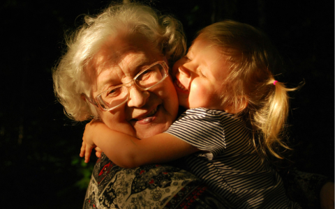 A young girl hugging her grandma