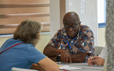 Prof Kwame Akyeampong sitting and speaking with Dr Kris Stutchbury