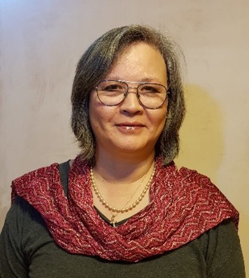 A portrait photo of Linda stood in front of a neutral background