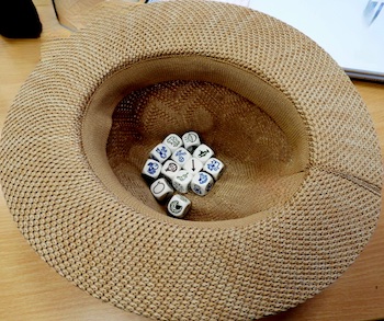 a bunch of storycubes inside a hat