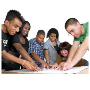 A group of people stood pointing at paper on a table