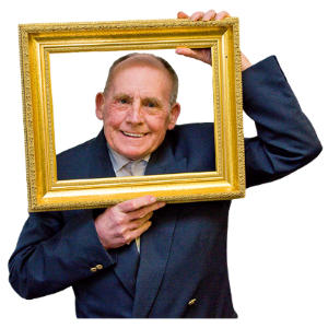 A man in a suit holding a frame