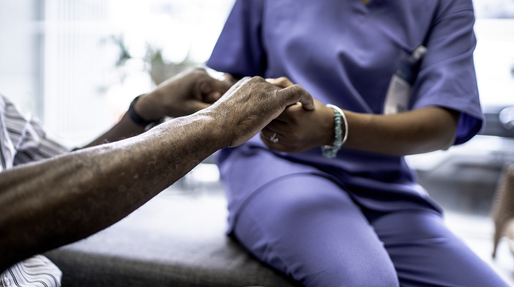 carer holding hands of patient