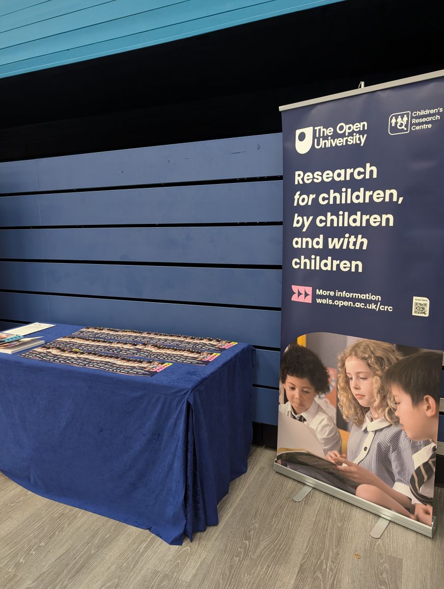 An image of a table with brochures and a pull-up banner detailing information about the CRC