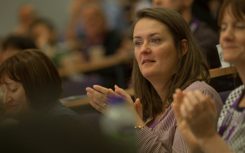 Photograph of Petra Vackova in the audience of an academic conference (pre-COVID).