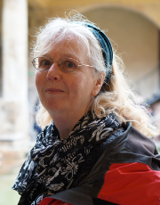 Portrait of Professor Rebecca Ferguson. She has long fair hair with a headband holding it off her face, and is wearing glasses