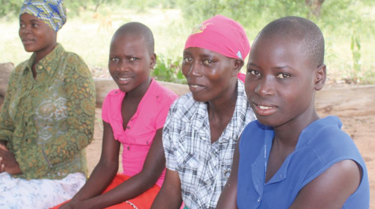 Four female participants in the Zimbabwean SAGE project are shown sitting in a line,