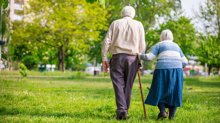 Senior couple walking outdoors in spring