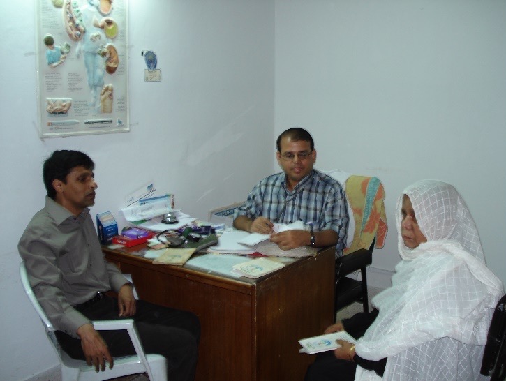 a researcher interviewing a local couple in Bangladesh