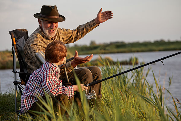 and old man and a child fishing together