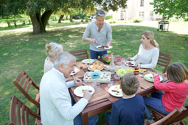 a multigenerational family having an outdoor meal