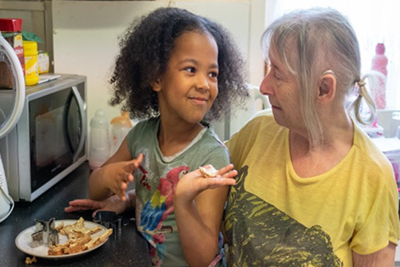 An older woman and young child in the kitchen