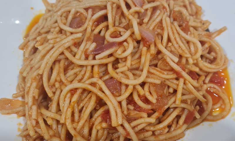 a photo of a portion of Jollof Spaghetti 