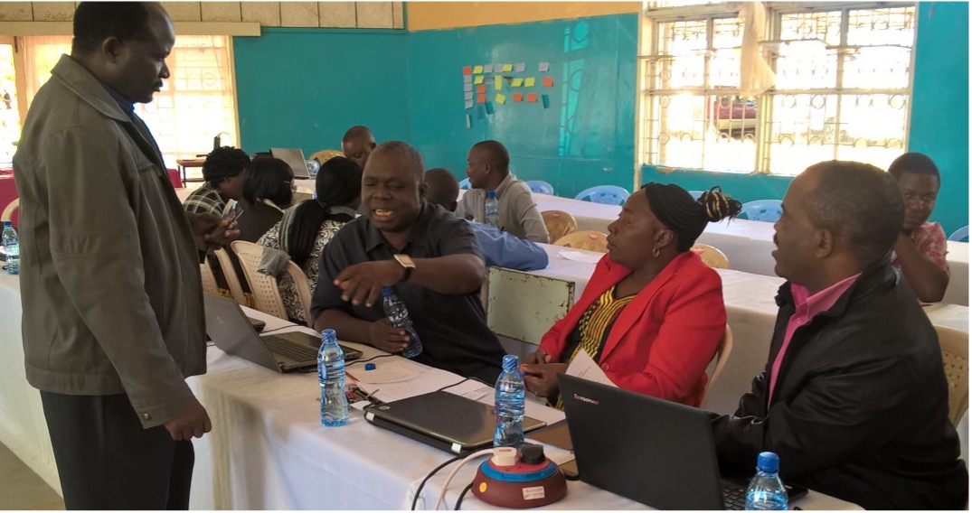 A group of teachers in a classroom workshop