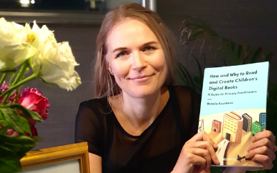 Photograph of Professor Natalia Kucirkova holding up her winning book.