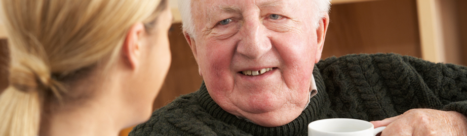 Elderly man with female care worker