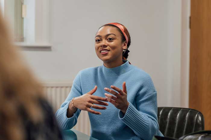 a young woman engaged in a group conversation