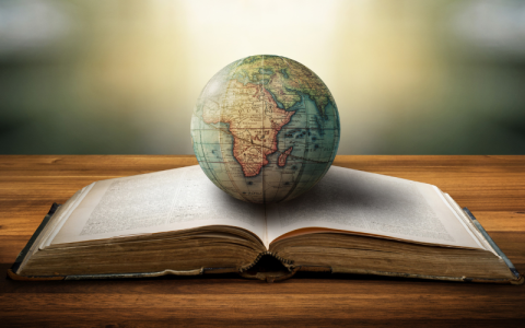 A globe on top of an open book