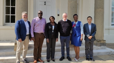 A group of people outside the OU's Walton Hall: left to right: Oli Biard, Dr Eric Addae-Kyeremeh (Head of School ECYS), Dr Beatrice Inyangala, Andrew Law, Hellen Wamittah (Kenya Ministry of Education), Leo Liu (OU Business Development Unit)
