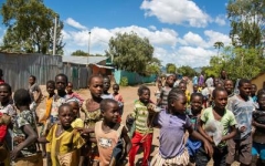 a group of African children playing togeher