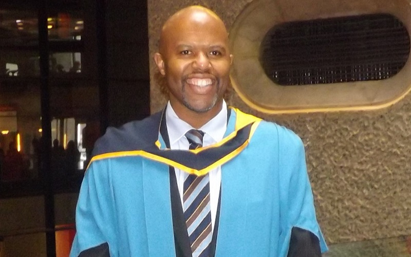A photograph of Adrian Rollins at his OU Masters Degree in Education graduation ceremony 2013.