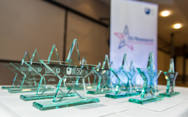 Photograph of glass Research Excellence Award trophies on a table at the 2019 ceremony.