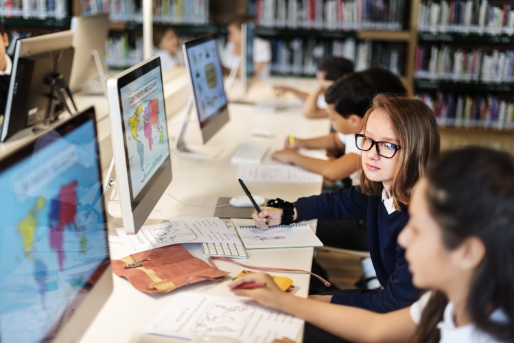 Image shows kids using computers.